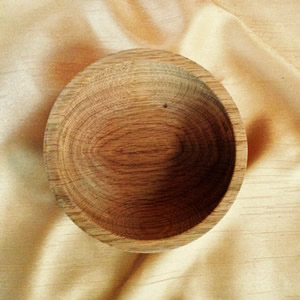 Hand turned wooden bowl and cream tablecloth