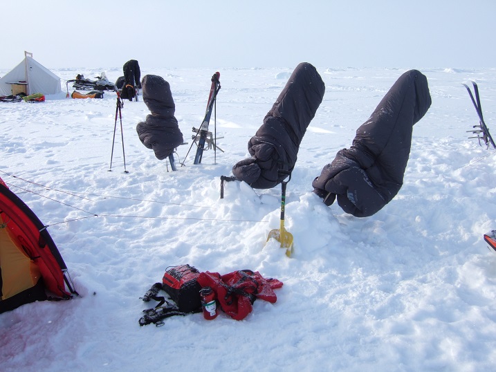 Airing the sleeping bags over the skis each evening to help get rid of the frozen moisture.