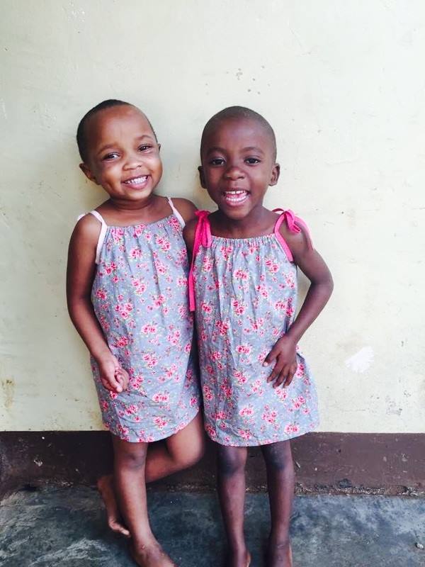 Two very happy girls in Africa wearing dresses I've made!
