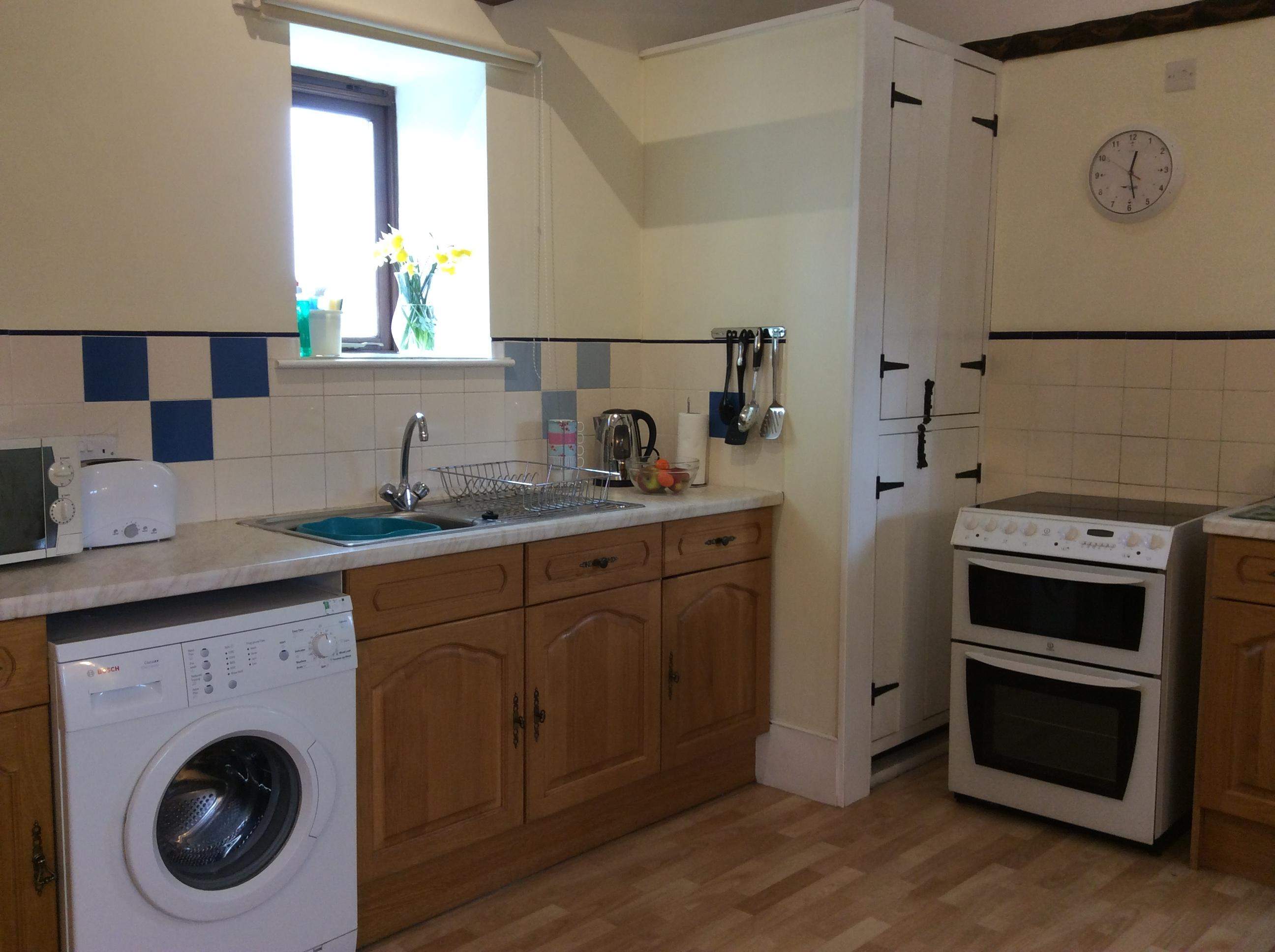 full size oven with ceramic hob and grill, microwave, full size fridge freezer, washing machine