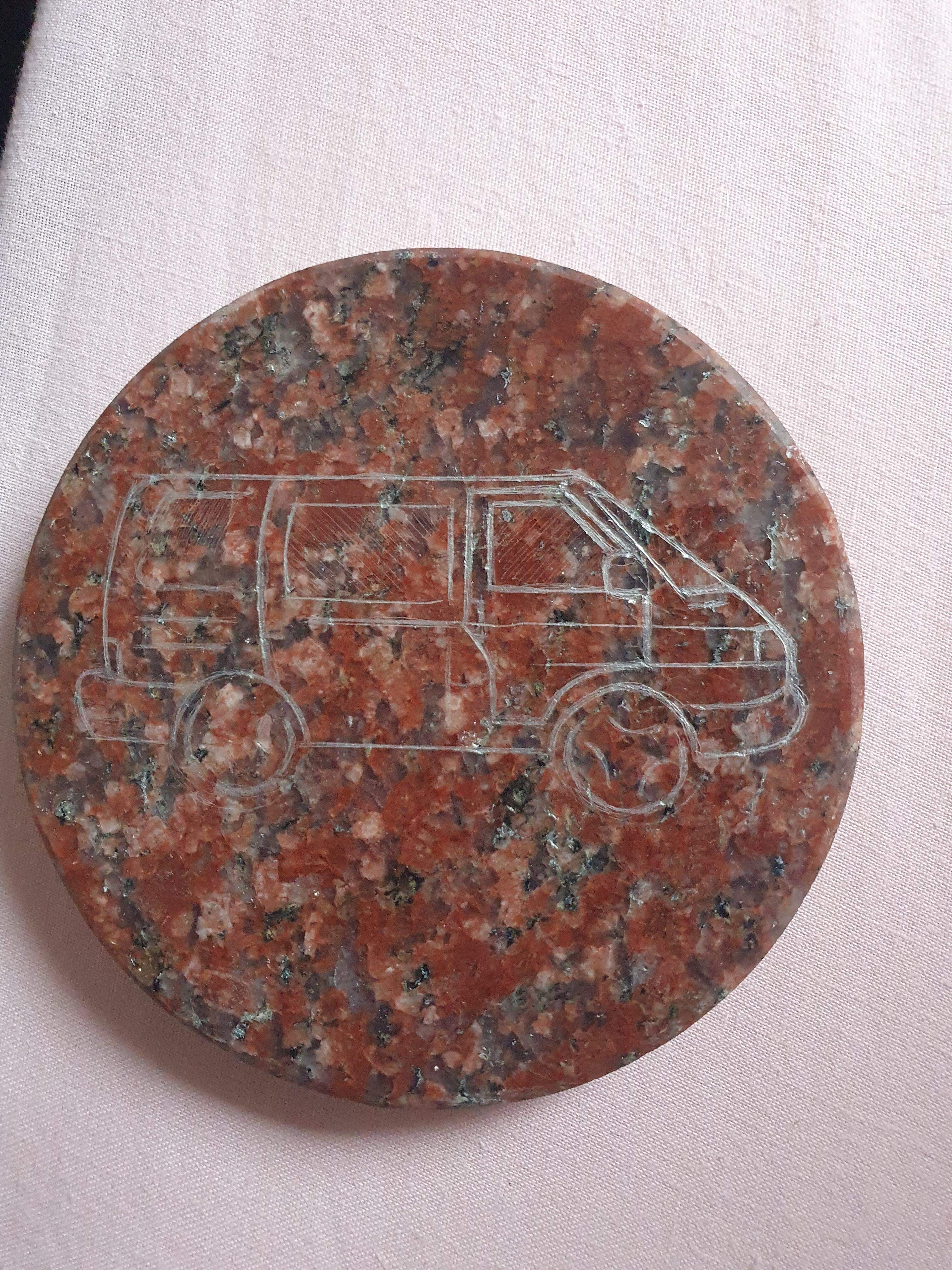 A Coaster with a VW Camper van on it.