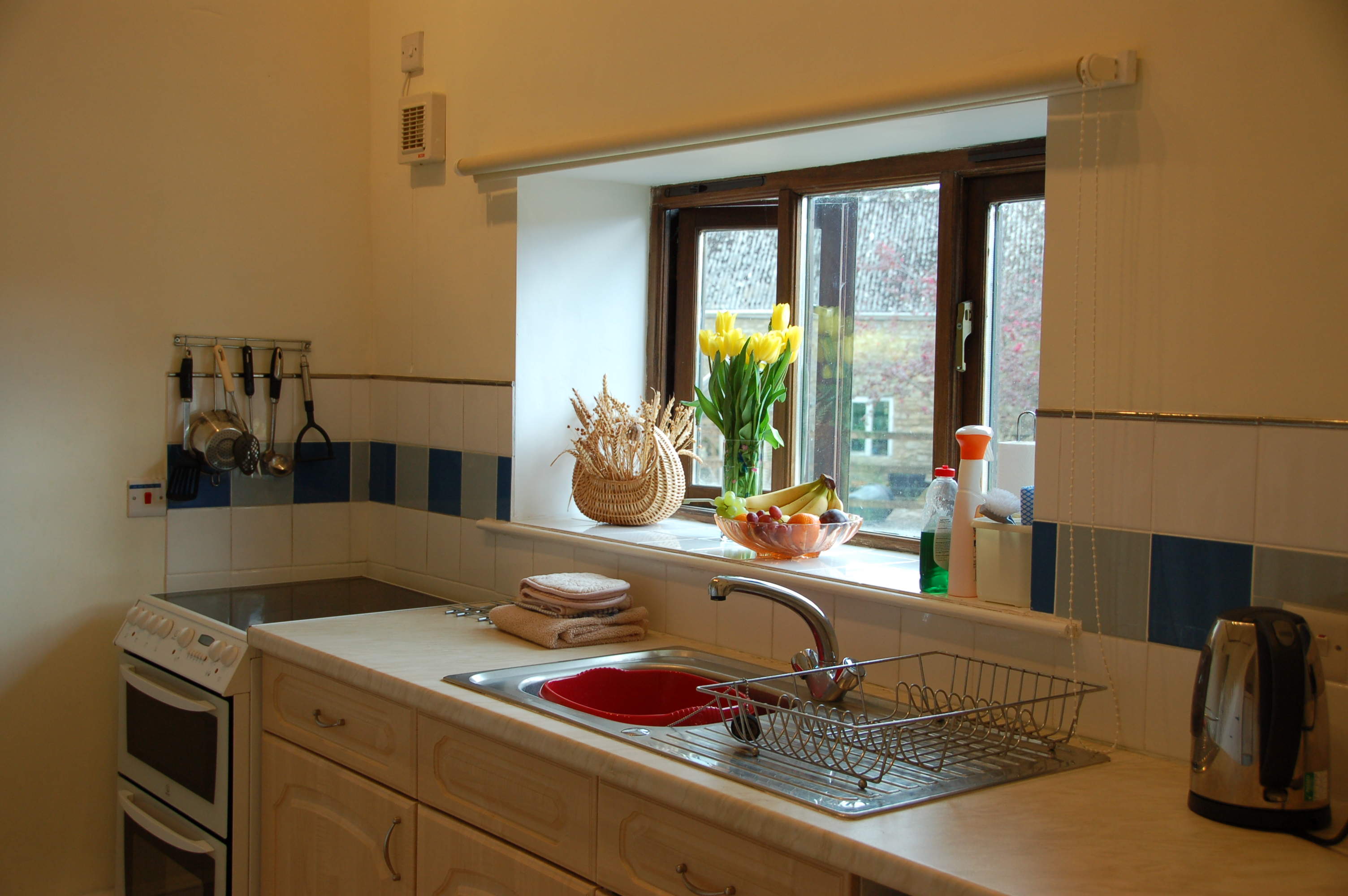 fully fitted kitchen with full size oven with ceramic hob, microwave, full size fridge freezer