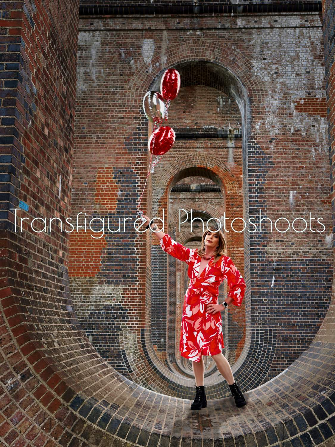 Berndette poses under the viaduct with balloons
