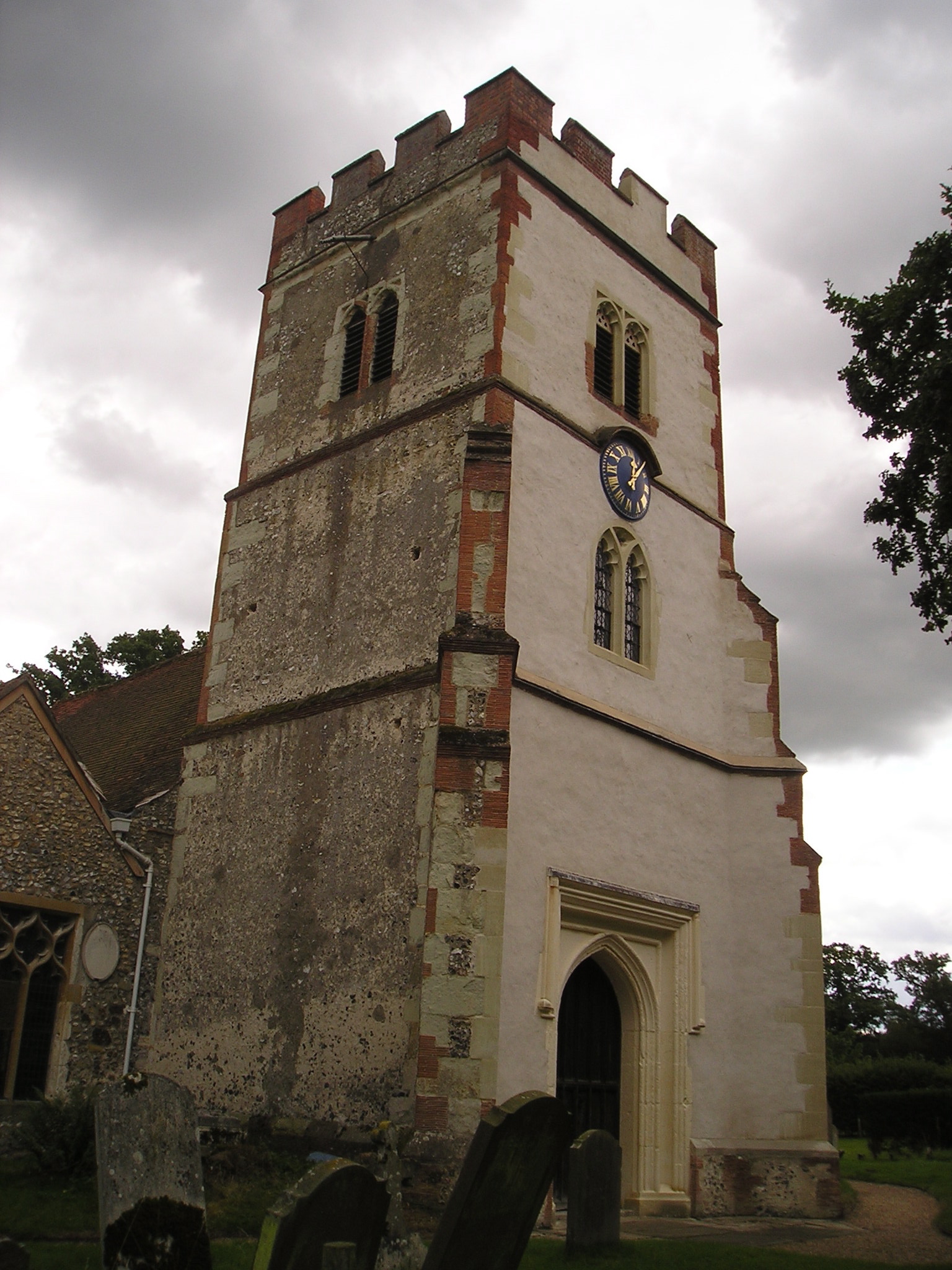 Ockham church tower between render projects.