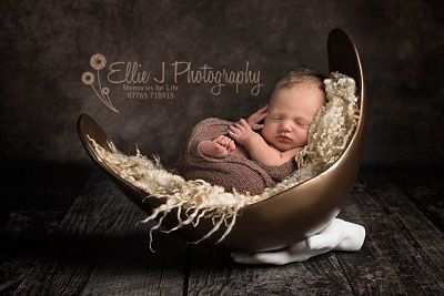Newborn shoot with by bump as a bowl and Dad's hand as a stand