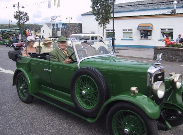 Green Rolls Royce being driven at a classic car event in Kirkcudbright