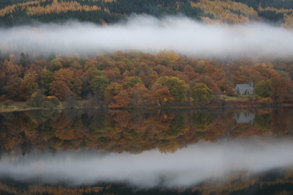 Autumn reflections on Loch Achray in The Trossachs
