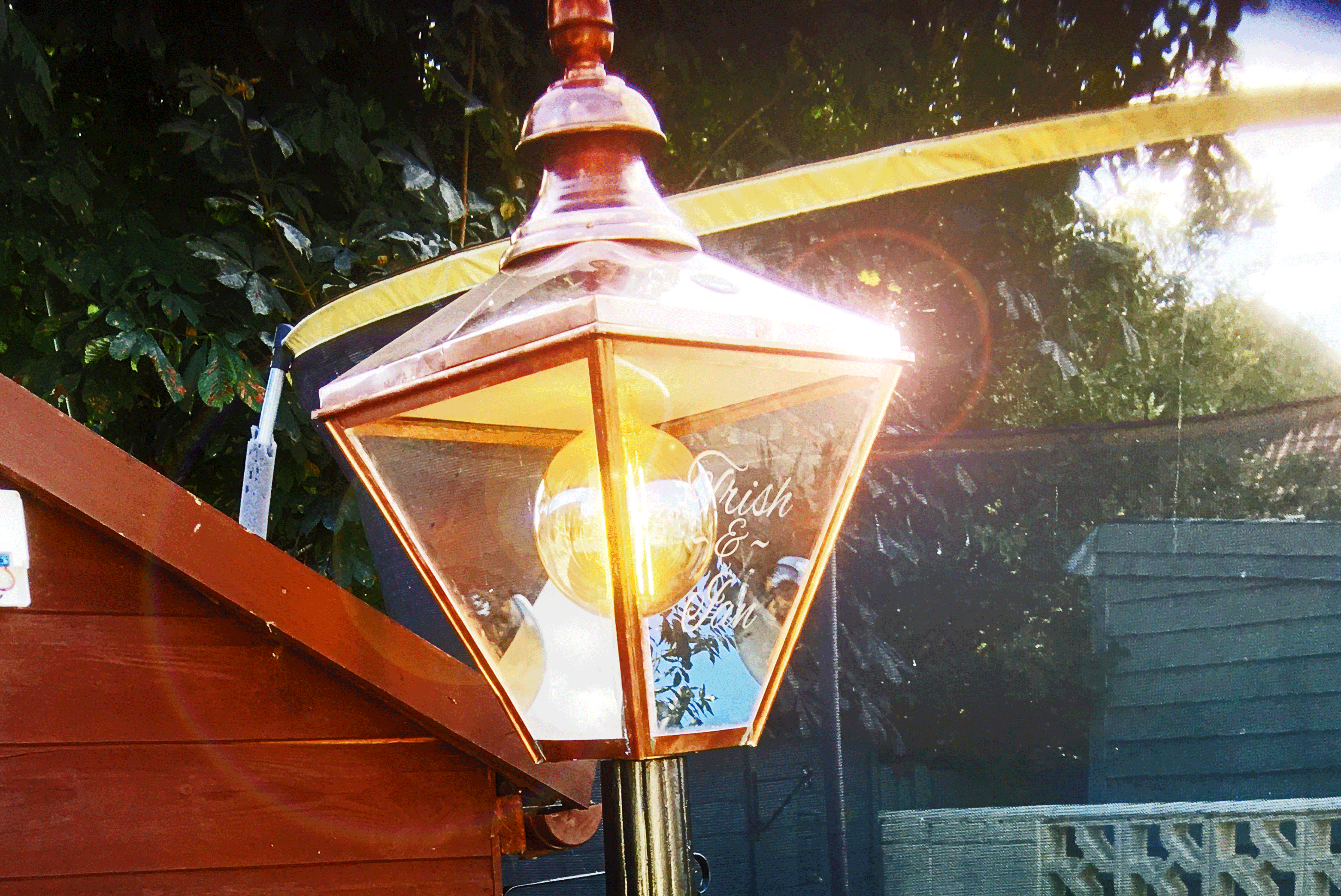 Garden lamp with engraved panel