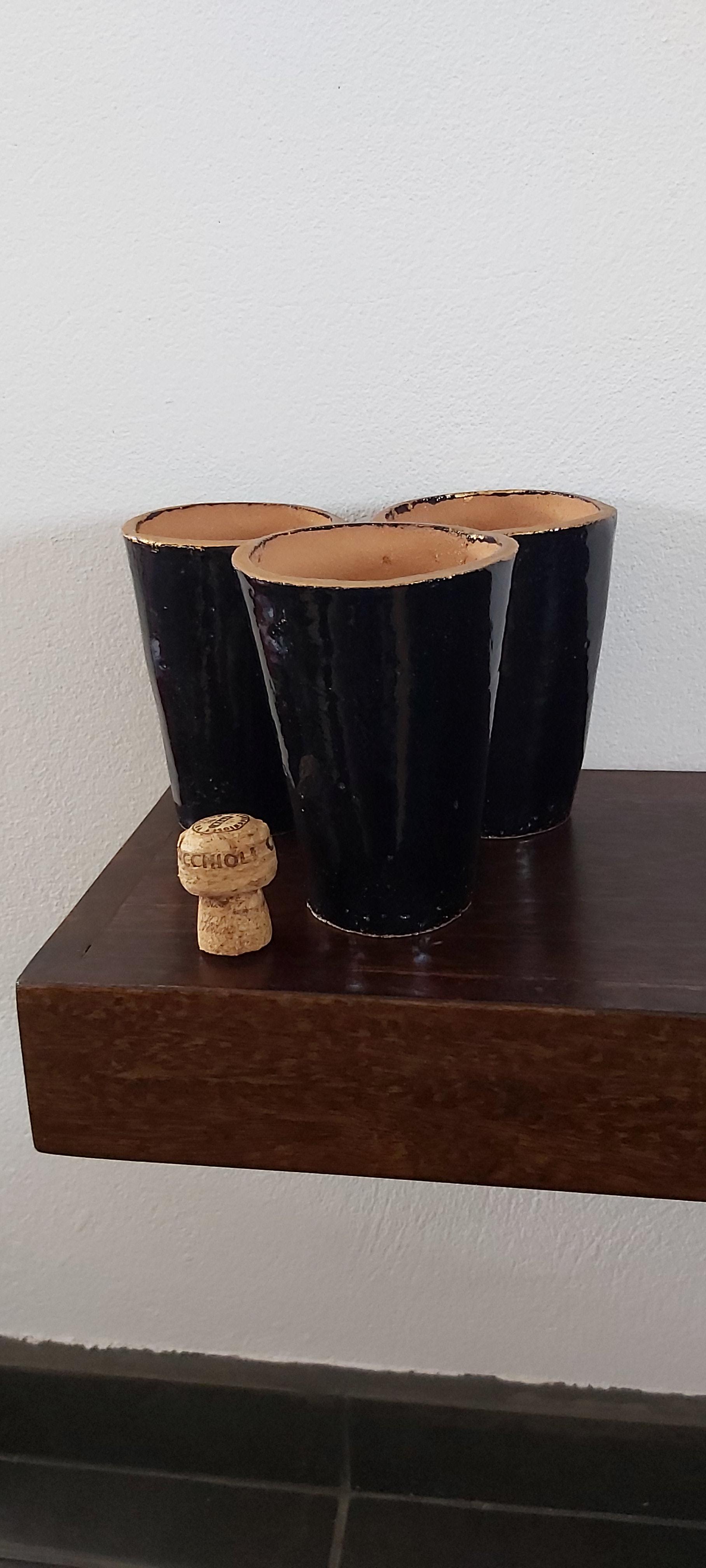 Set of three terracotta beakers/vases