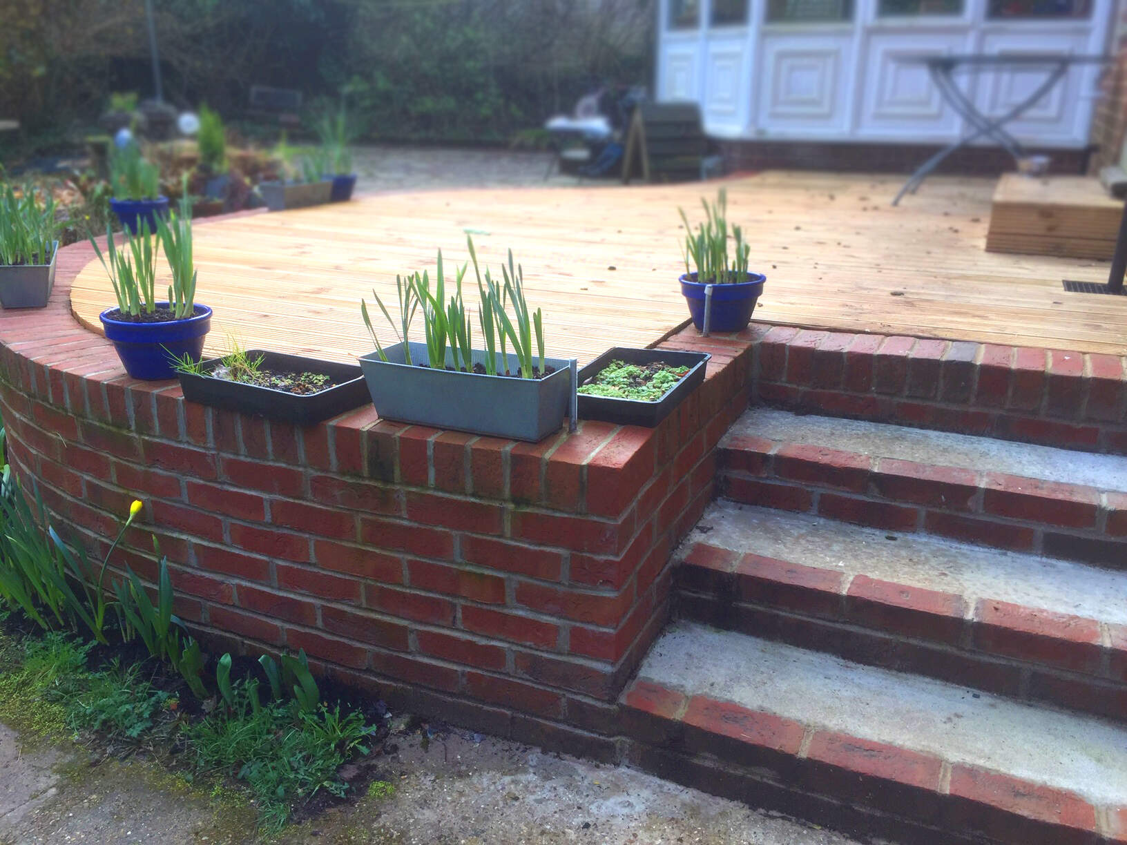 Creation of a decking area with brick perimeter and steps