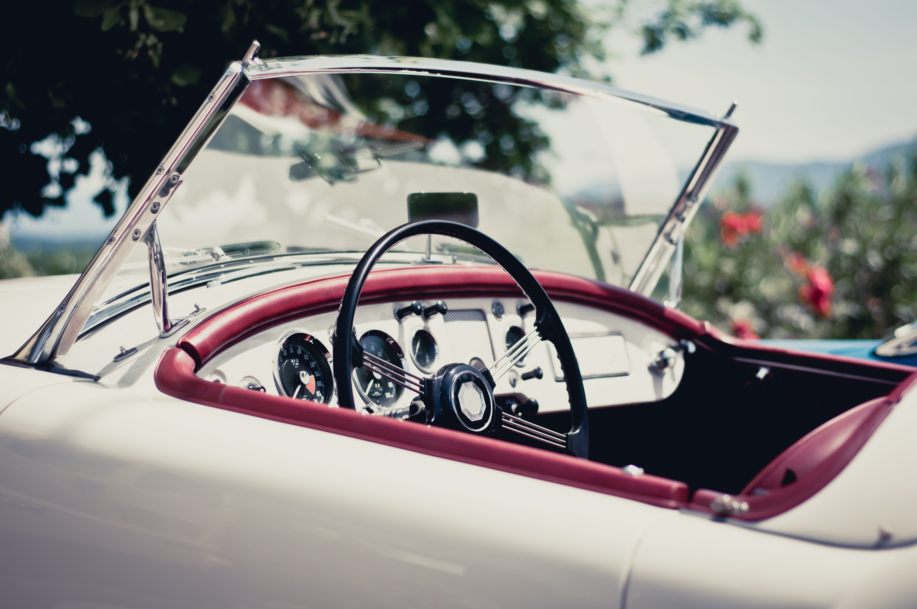 white-convertible-with-red-accents-on-a-sunny-dayjpg