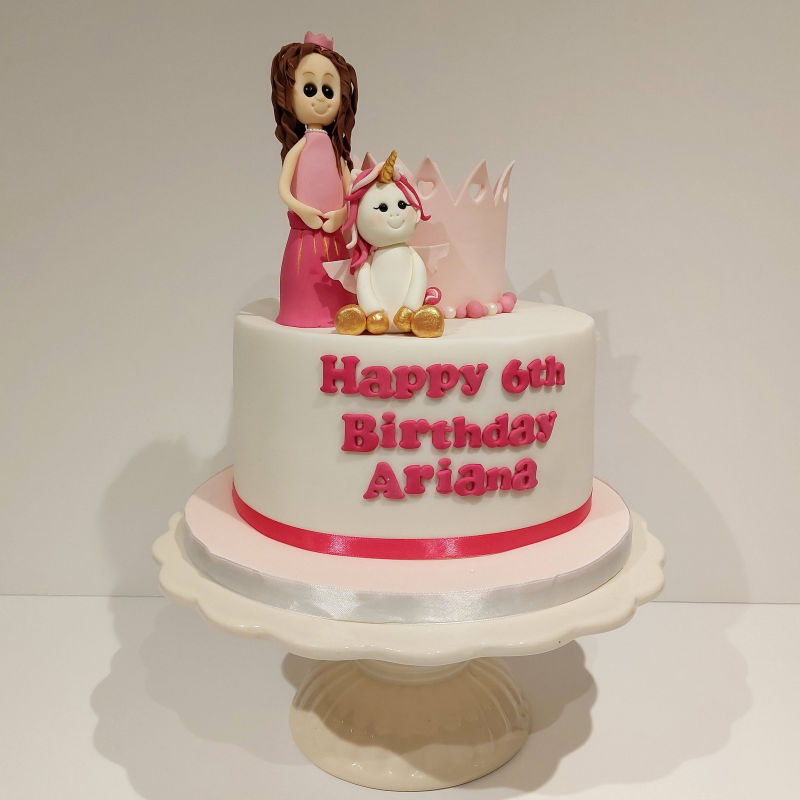 Princess themed birthday cake with a unicorn.