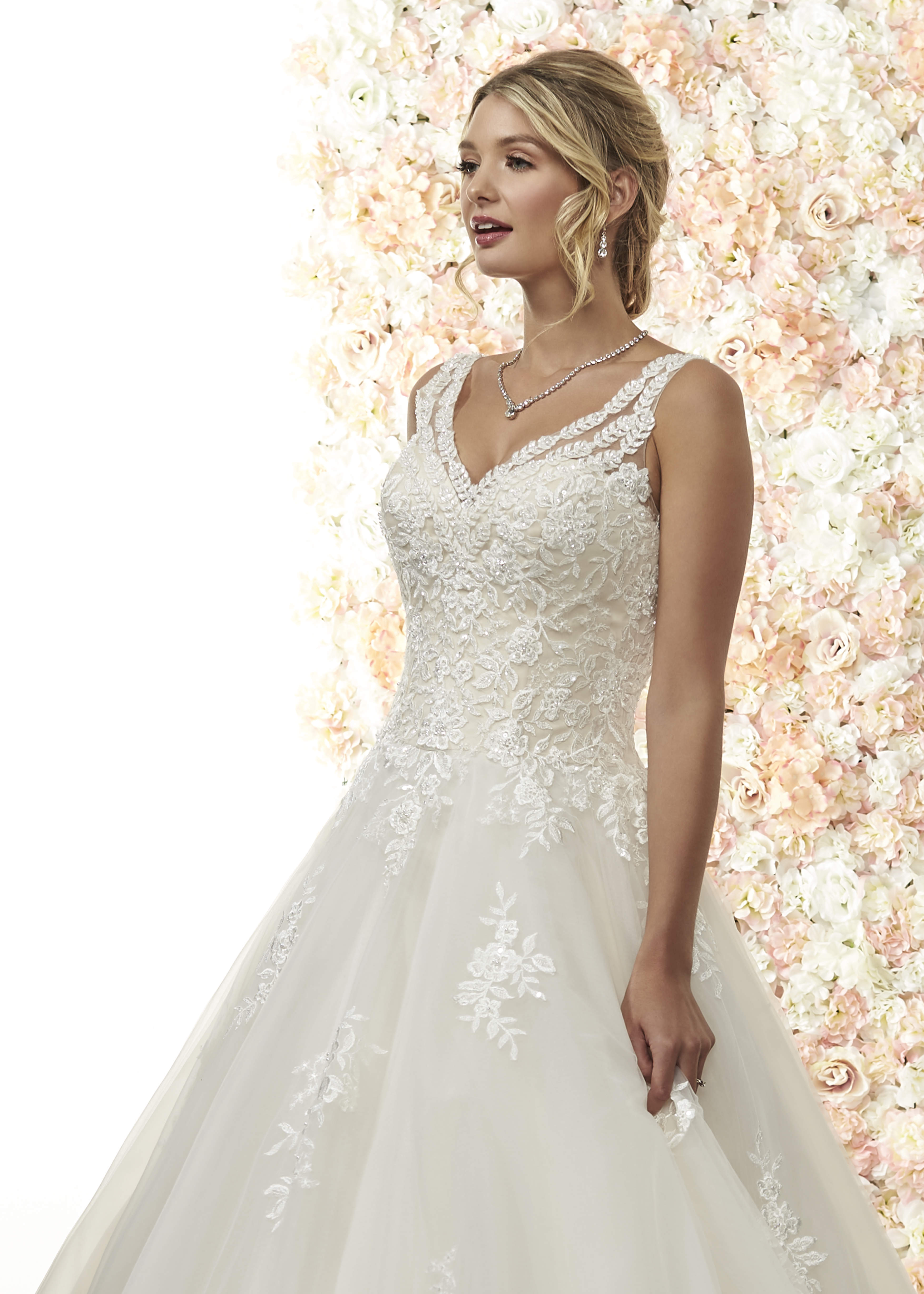A sophisticated ballgown style, with a v neckline, illusion lace straps, lace bodice, lace motifs.