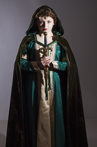 Green gown with gold front panel. Lady holding a sword and wearing a velvet cape