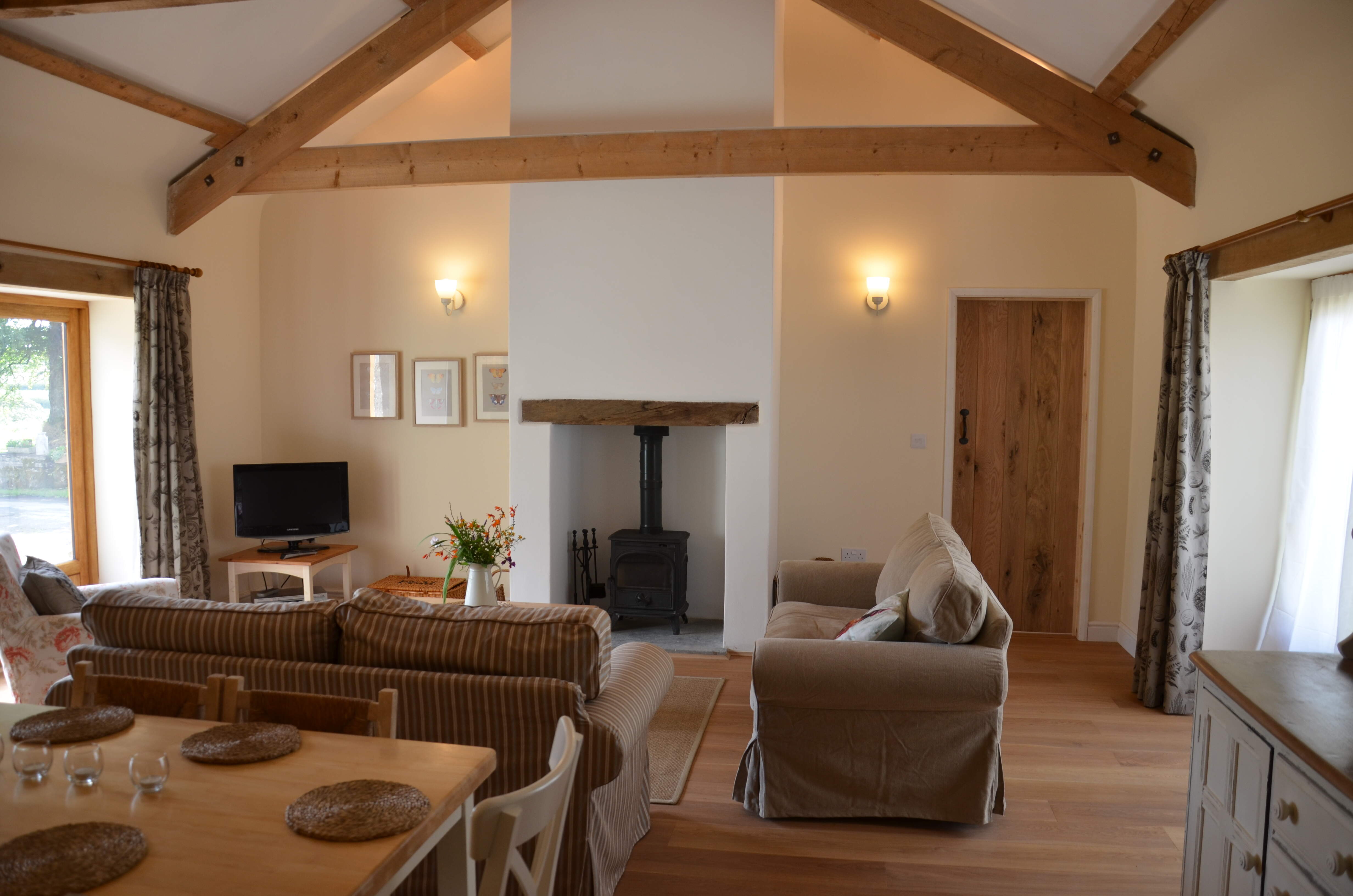 The area includes a wood burning stove along with a large basket of wood