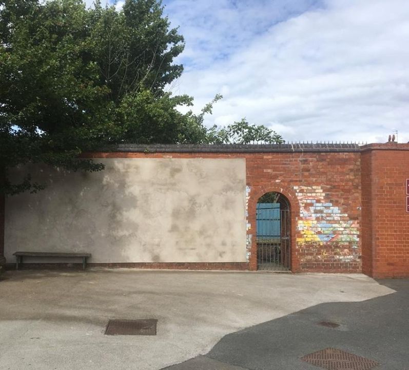 The rendered wall at Harborne Primary School before the mural begins
