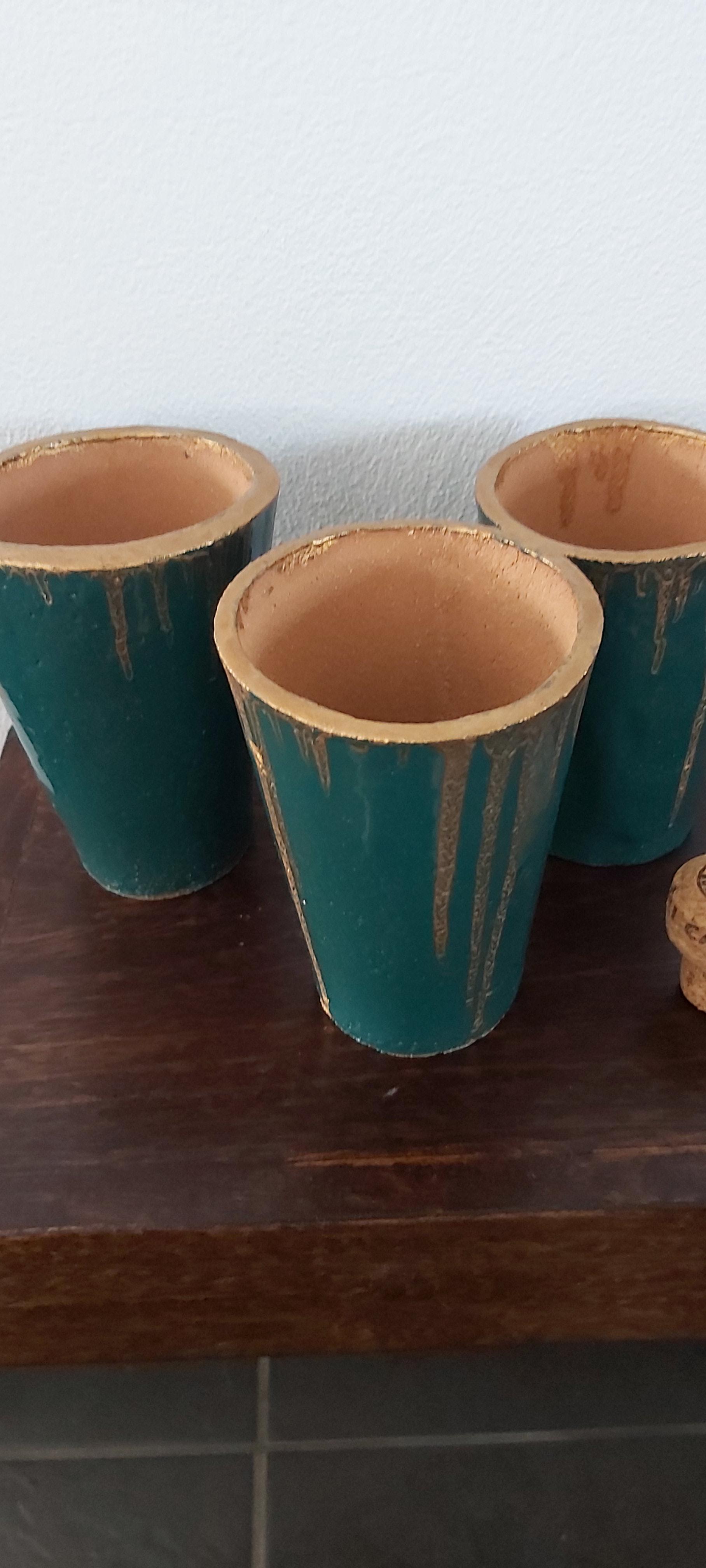 Set of three terracotta beakers/vases