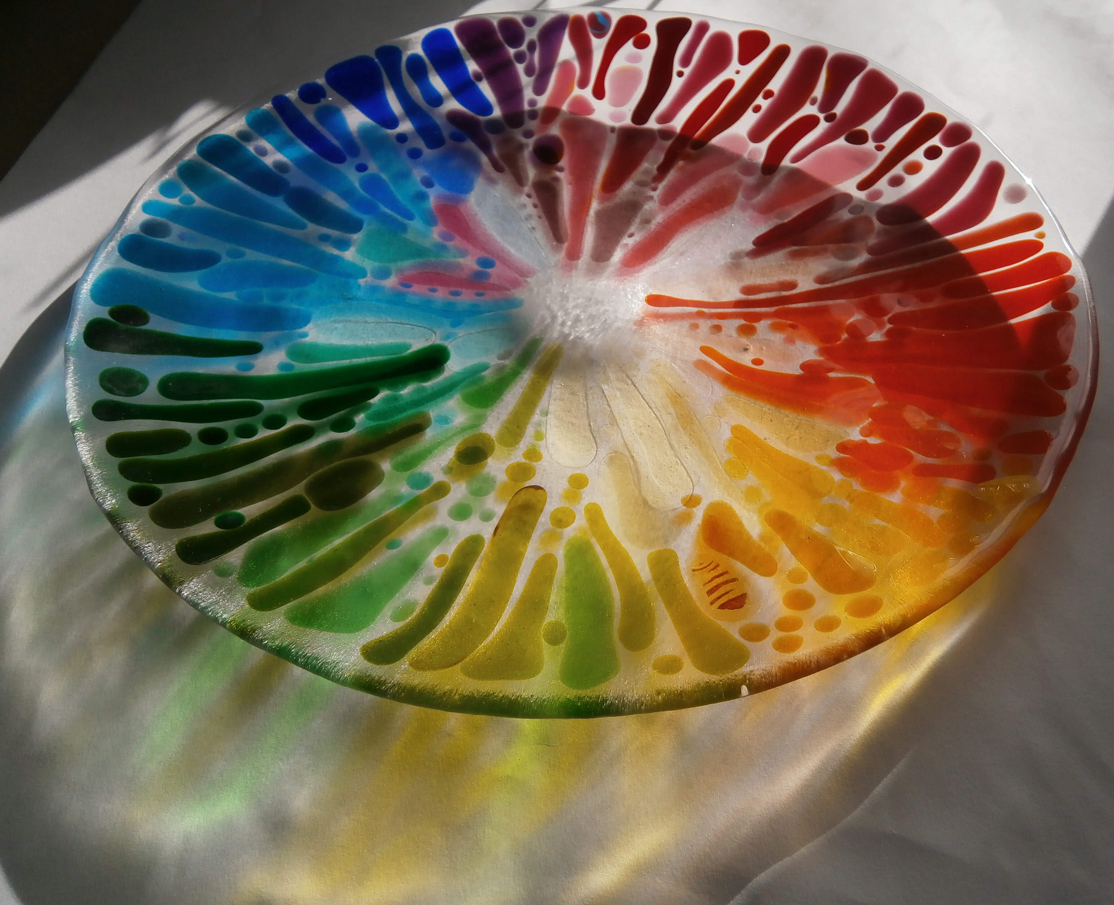 Glass dish,  rainbow colours in sunshine showing colours