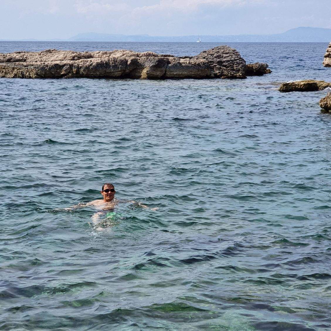 A swimmer floating on their back in the sea