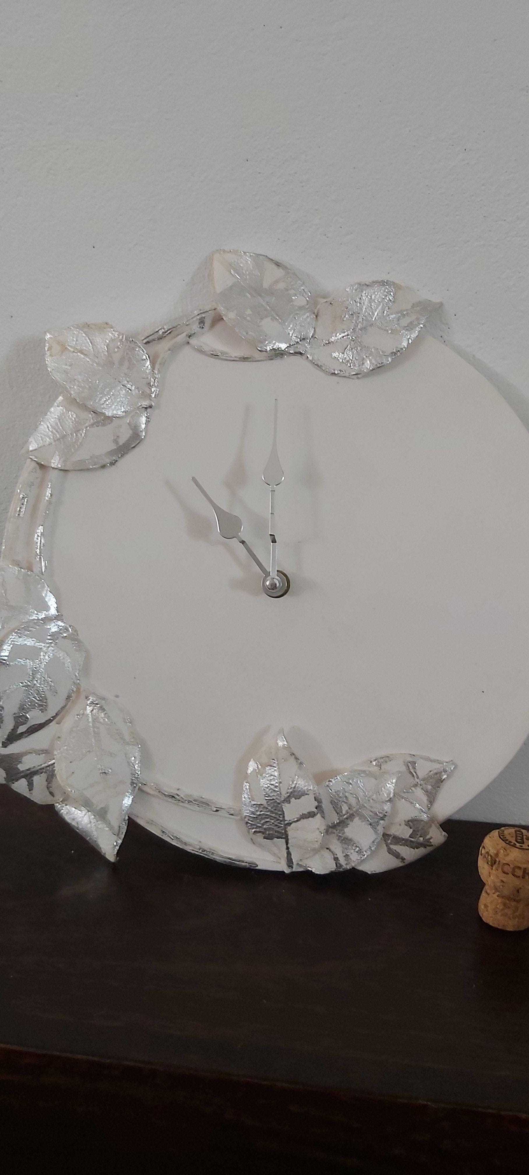 Porcelain clock with silver leaf design