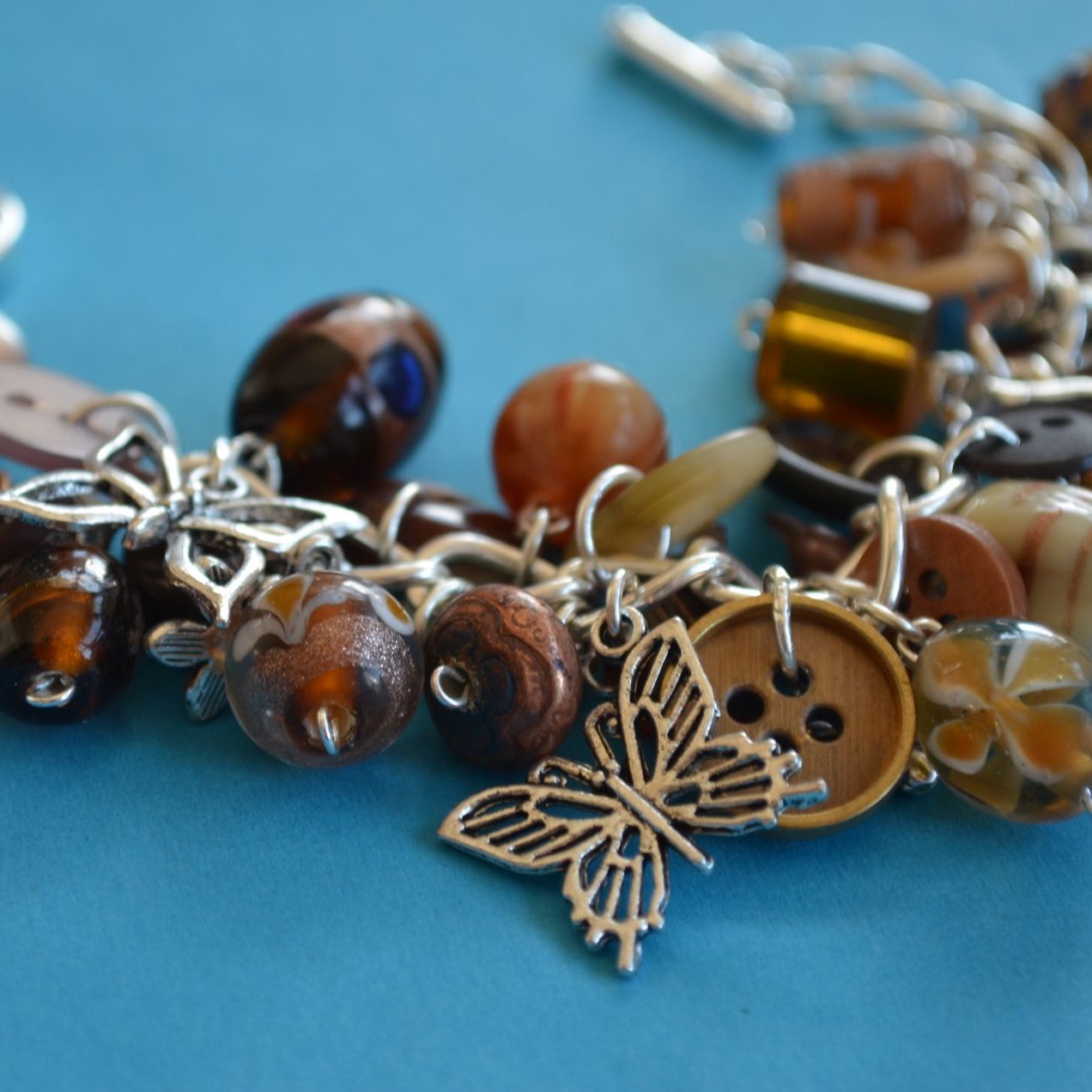 Button, Bead & Butterfly Charm Bracelet