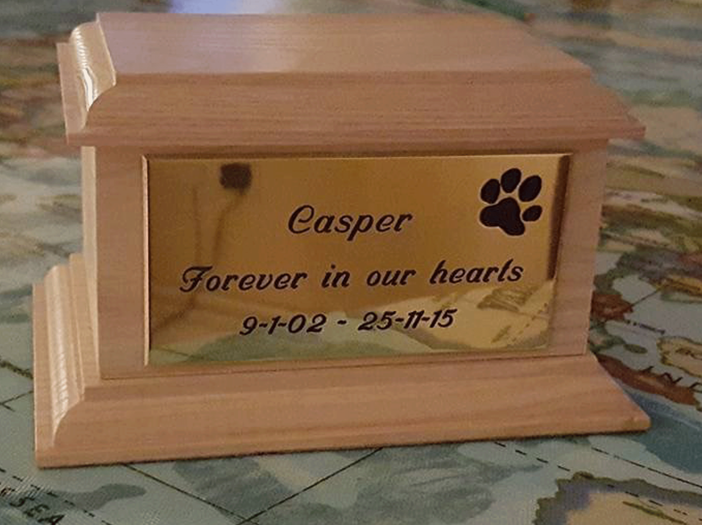 pet memorial plaque in brass and mounted on ashes casket