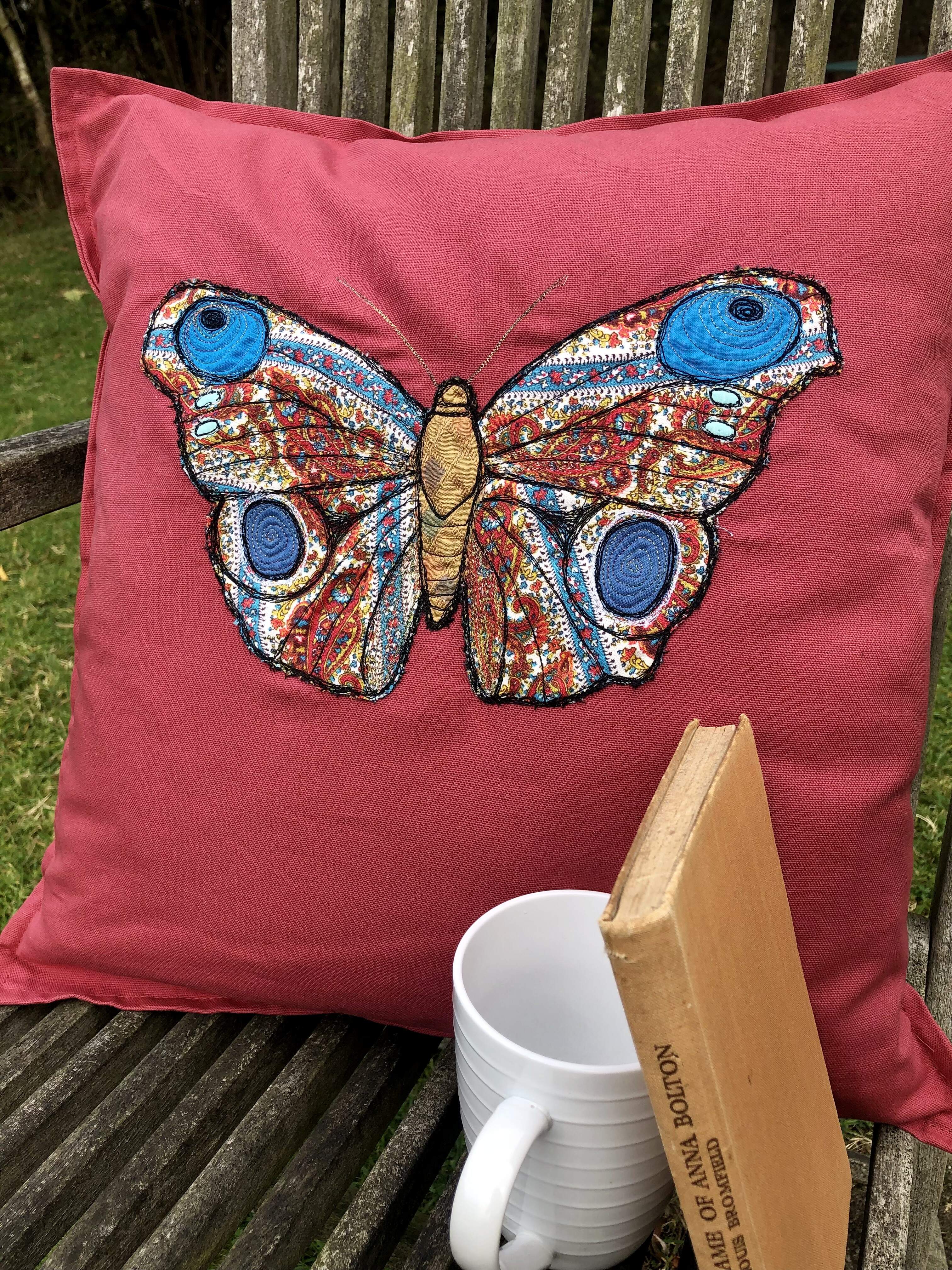 Vibrant sparkly and colourful hand decorated butterfly cushion.
