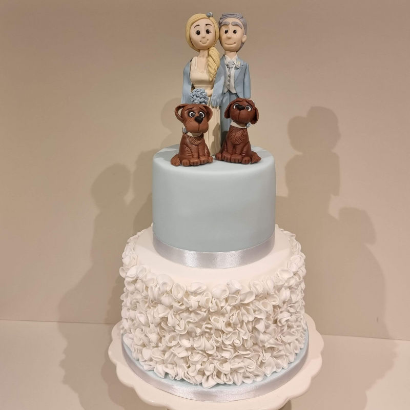 Wedding Cake with Ruffles bottom tier and bride and groom topper with pet dogs.