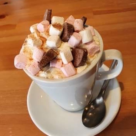 Cadburys hot chocolate, topped with cream, marshmallows  & crunchy pieces