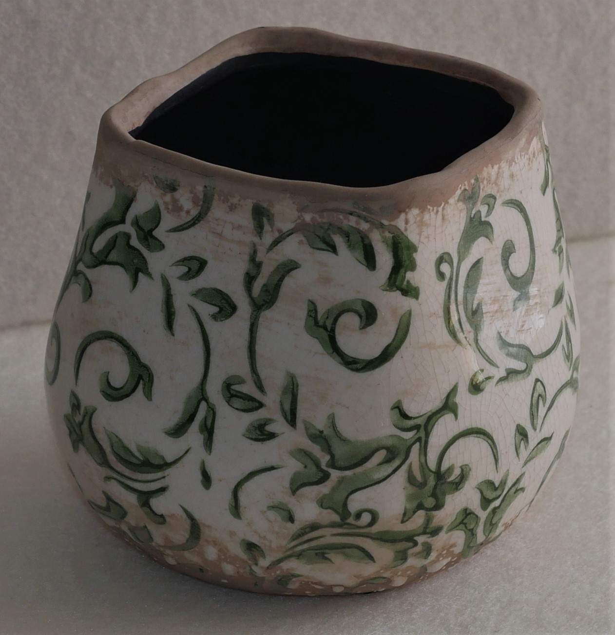 Small square green and white pottery plant pot holder.