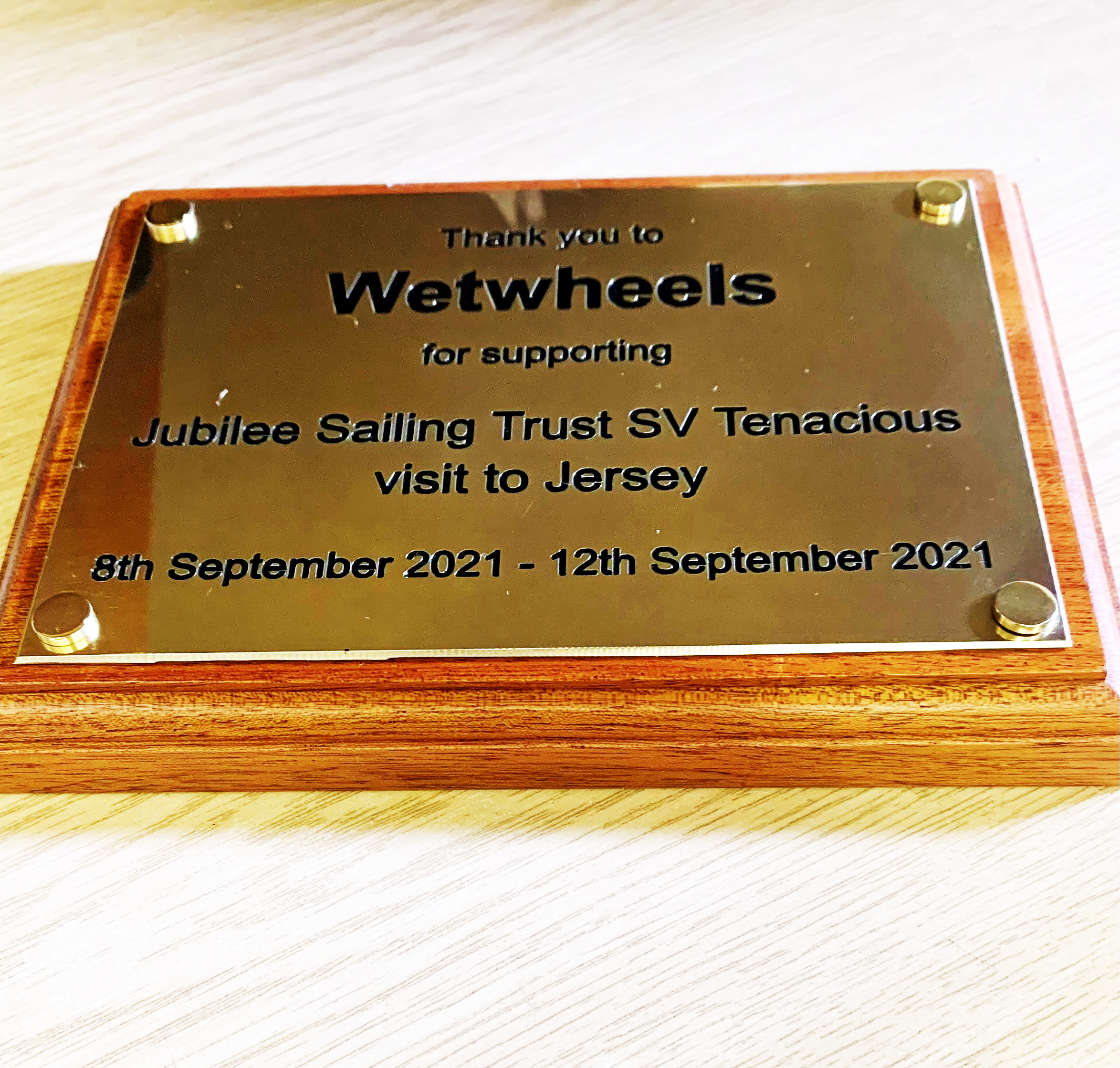 Small brass plaque engraved and filled black, on dark wood backing board #jubileesailingtrust #svtenacious