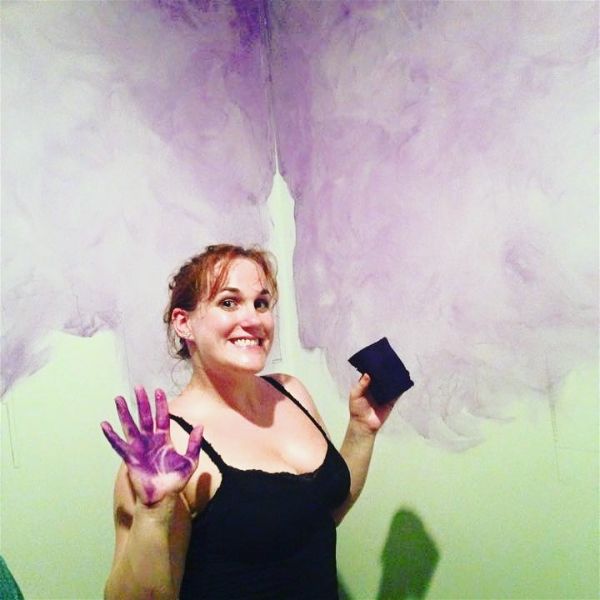 Rachel Akers getting messy at work on a mural