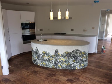A designer kitchen with individually selected Quartz worktops with intricate shaping.