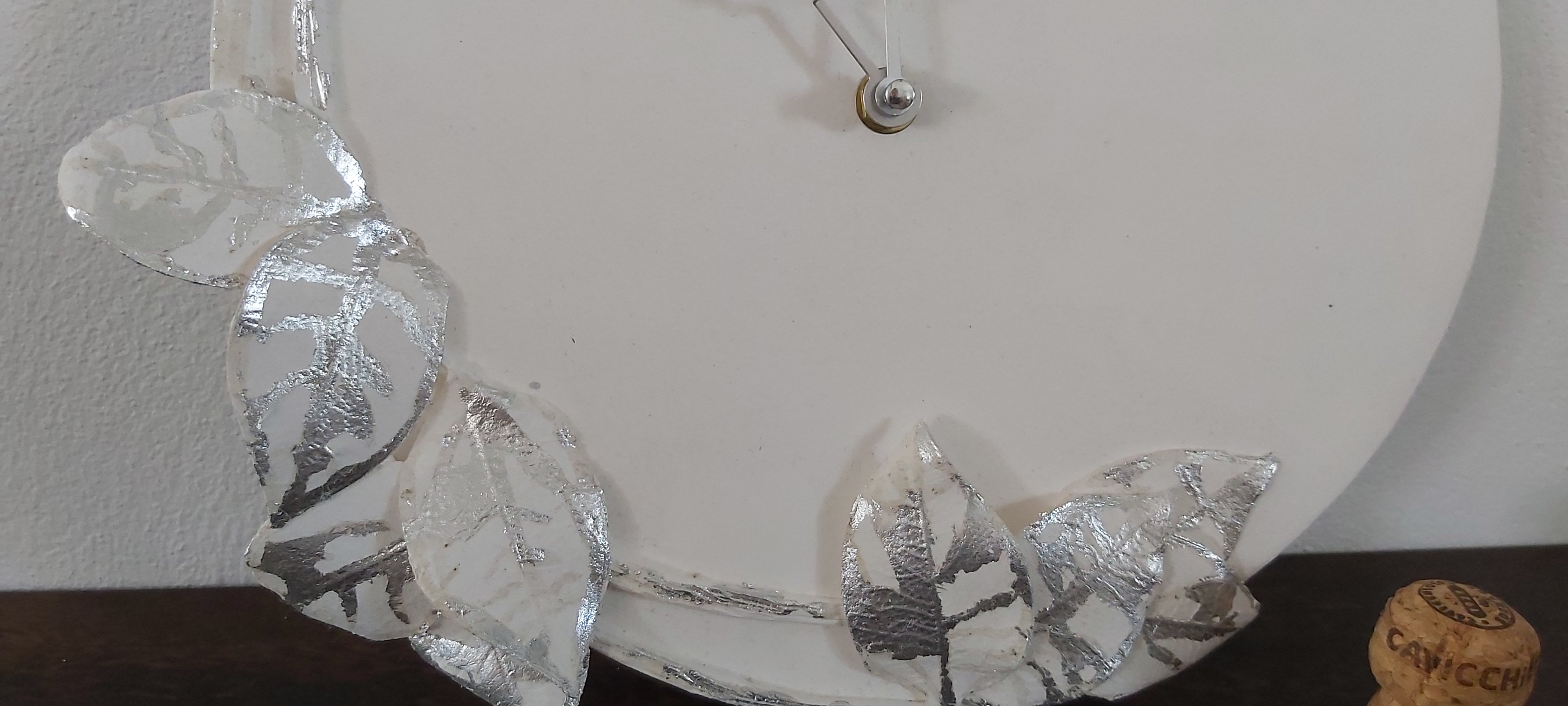 Porcelain clock with silver leaf design