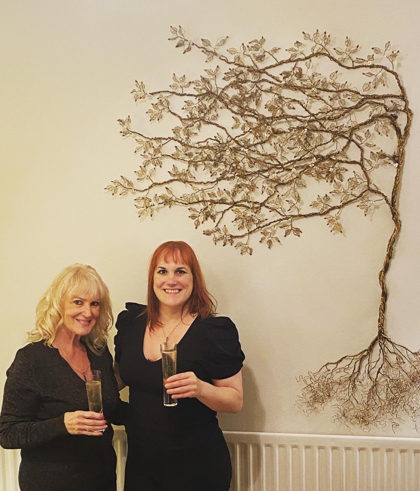 Artist Rachel AKers with her piece 22blossom in the wind22 wire tree sculpture jpg