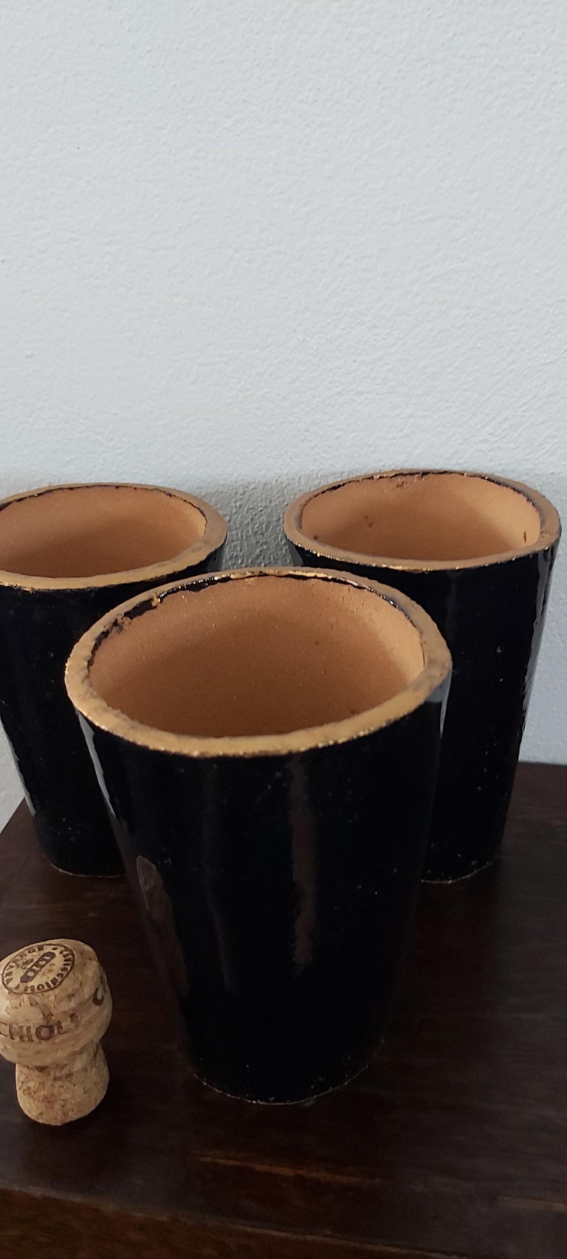 Set of three terracotta beakers/vases