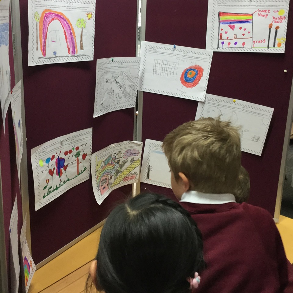 Harborne Primary School Students looking at the winning mural designs