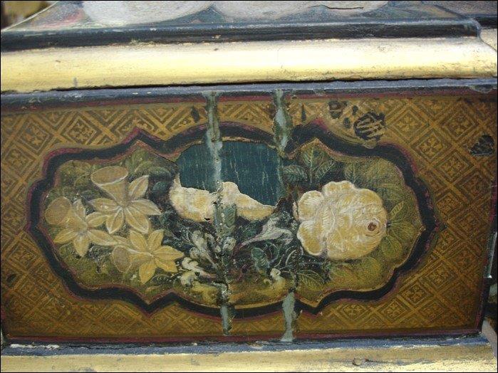 Detail of panel showing degraded varnish, damage to paper panel, failed repairs