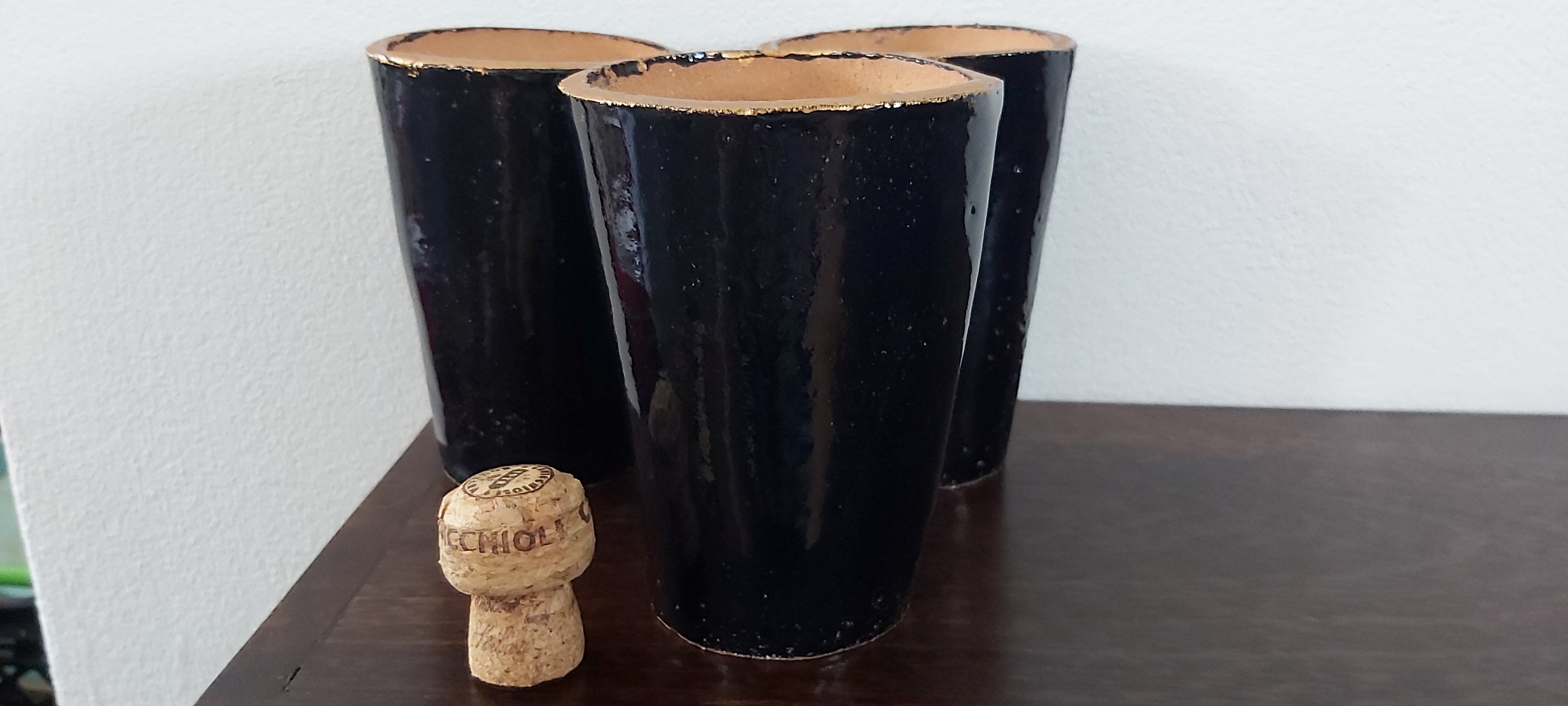 Set of three terracotta beakers/vases