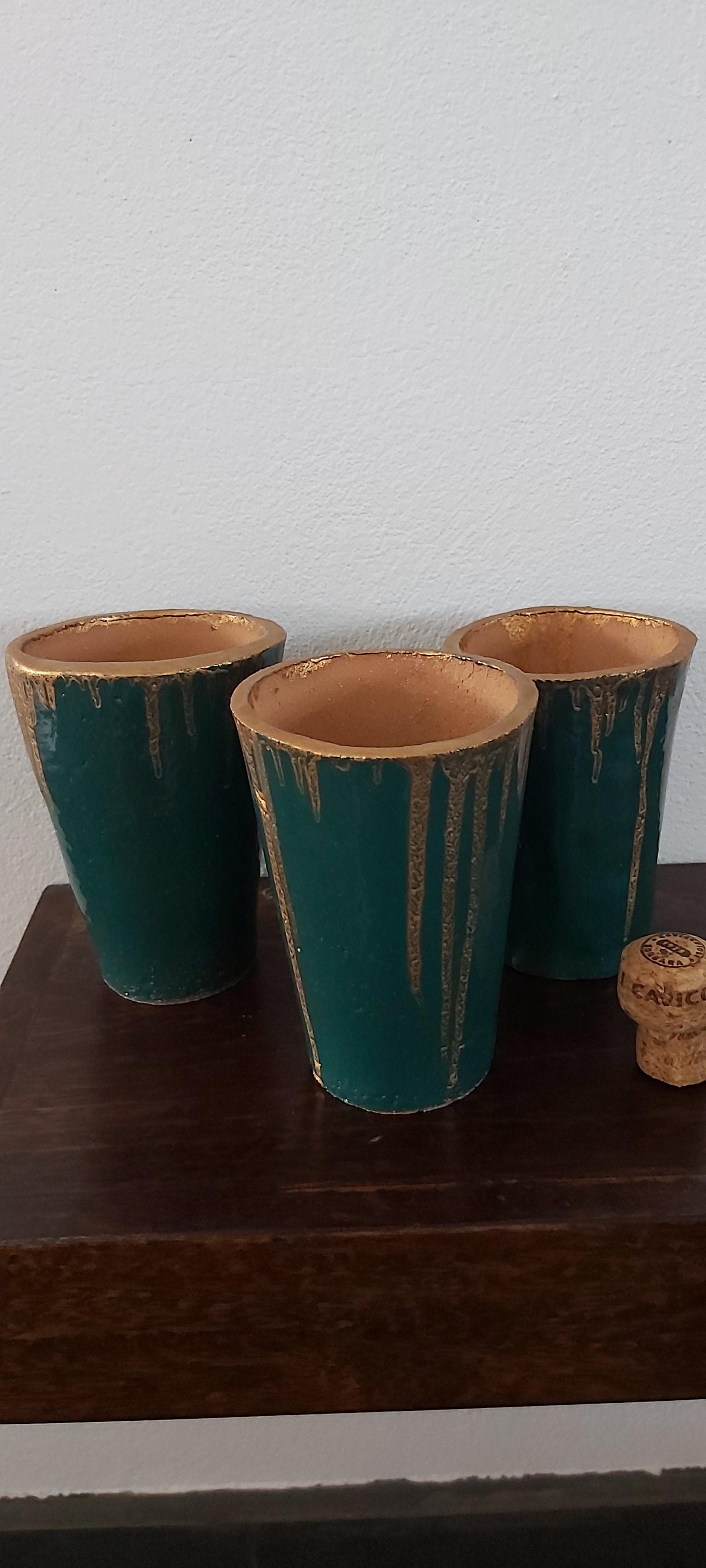 Set of three terracotta beakers/vases