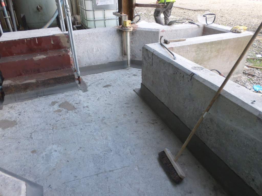 Installation of epoxy mortar coving at base of bund walls