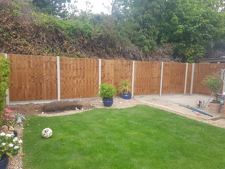 With concrete posts and concrete gravel-boards, fencing installed in Hoo