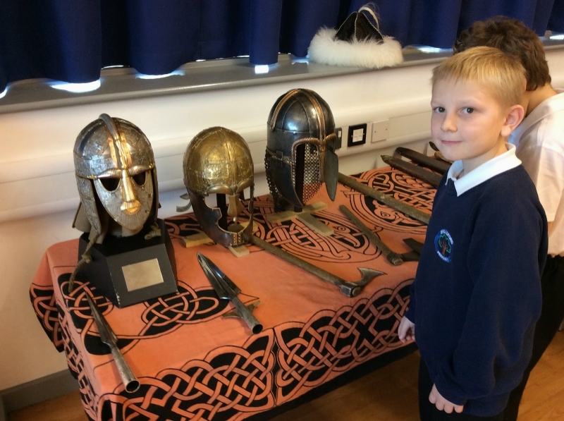 boy with our 3 famous helemts Jorvik, Vendal and Sutton Hoo.