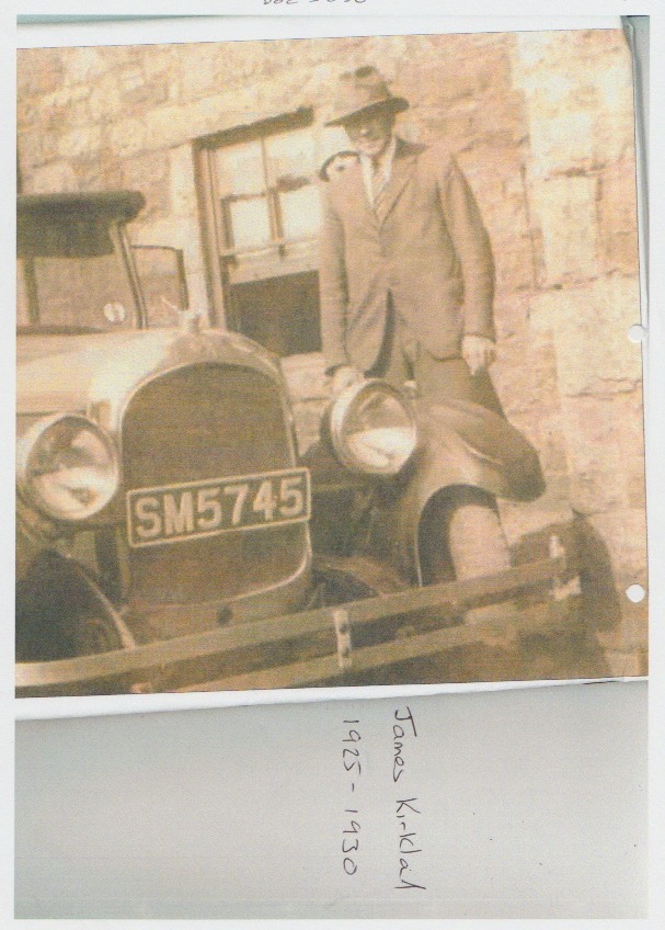 James Kirkland standing in front of a motor car bearing the number SM5745