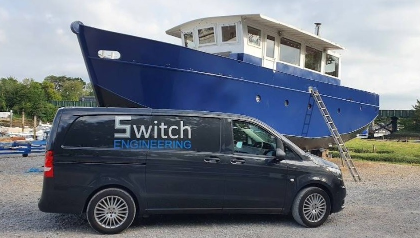 switch enginnering mercedes vito grey van parked in front of  blue boat on hard