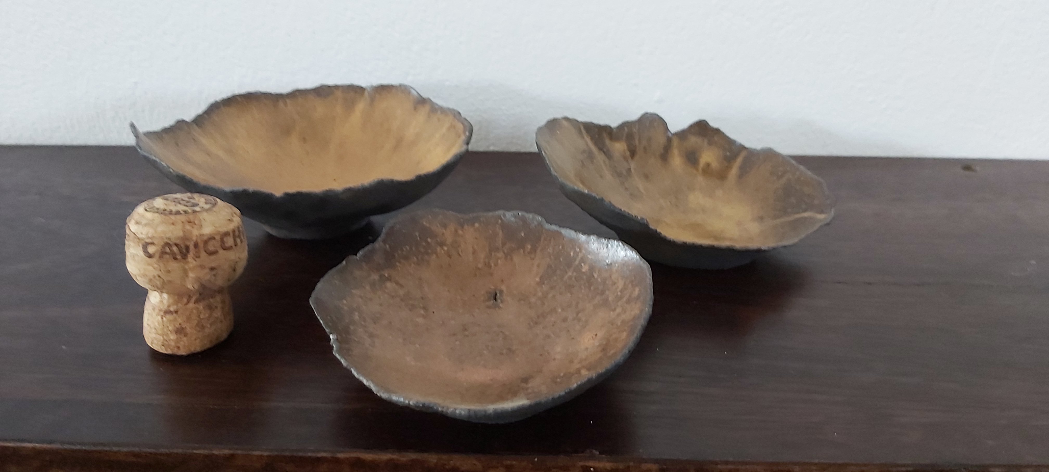 Set of three choc brown clay bowls with shino glaze