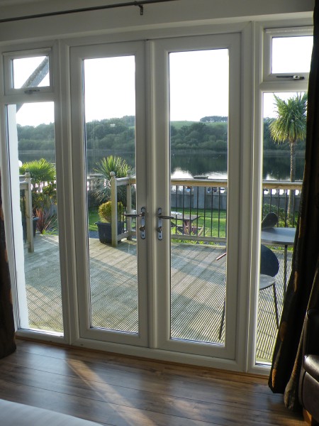French windows opening out onto decking facing the loch