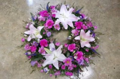 funeral wreath by flowers for you, dalbeattie, with white lillies and purple carnations