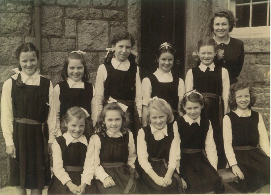 Ten young female pupils with their teacher