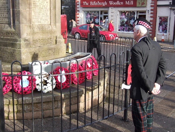 Viewing the wreaths around the war memorial in Moffat